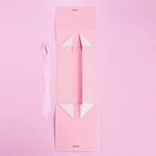 Caixa dobrável com fechamento magnético e laço decorativo.